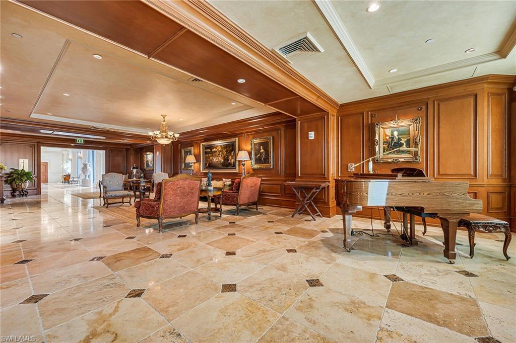 6597 Nicholas Boulevard, Unit 401 Naples, FL 34108 - Photo 18 of 28 a view of a big room with dining table and chairs