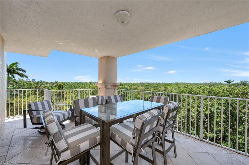 6597 Nicholas Boulevard, Unit 401 Naples, FL 34108 - Photo 2 of 28 a view of swimming pool with outdoor seating and city view