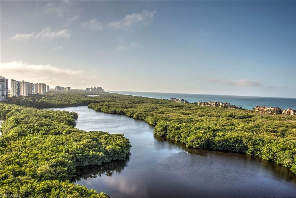 6597 Nicholas Boulevard, Unit 401 Naples, FL 34108 - Photo 25 of 28 a view of a lake with a city