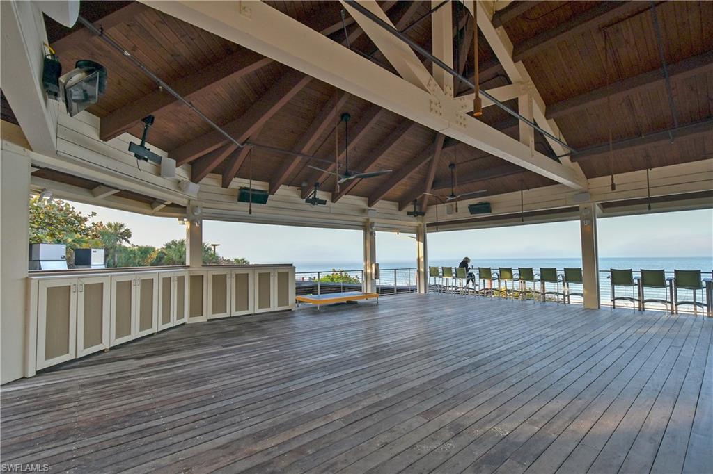 6597 Nicholas Boulevard, Unit 401 Naples, FL 34108 - Photo 26 of 28 a view of a car porch with wooden floors