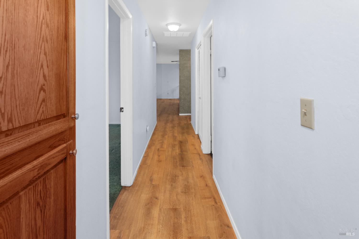 424 B Mason Street Healdsburg, CA 95448 - Photo 15 of 27 a view of a hallway with wooden floor and staircase