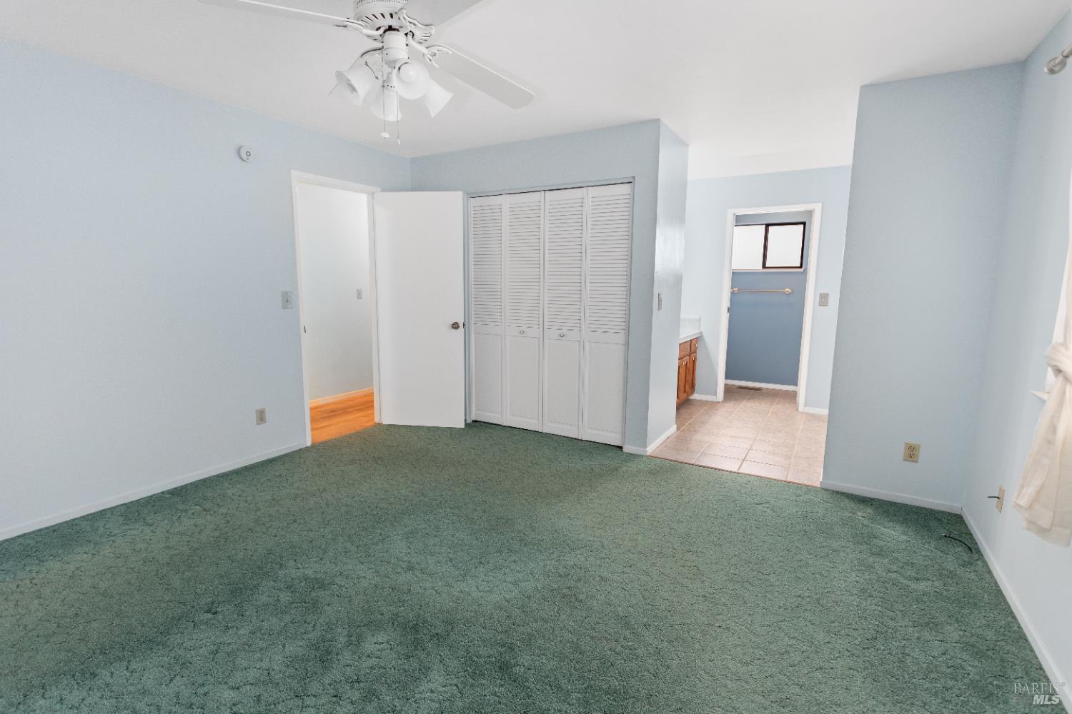 424 B Mason Street Healdsburg, CA 95448 - Photo 17 of 27 an empty room with chandelier fan and closet