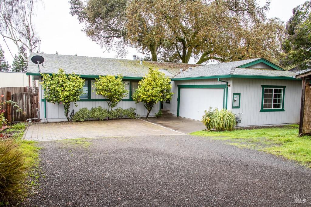 424 B Mason Street Healdsburg, CA 95448 - Photo 2 of 27 a front view of a house with a yard and garage
