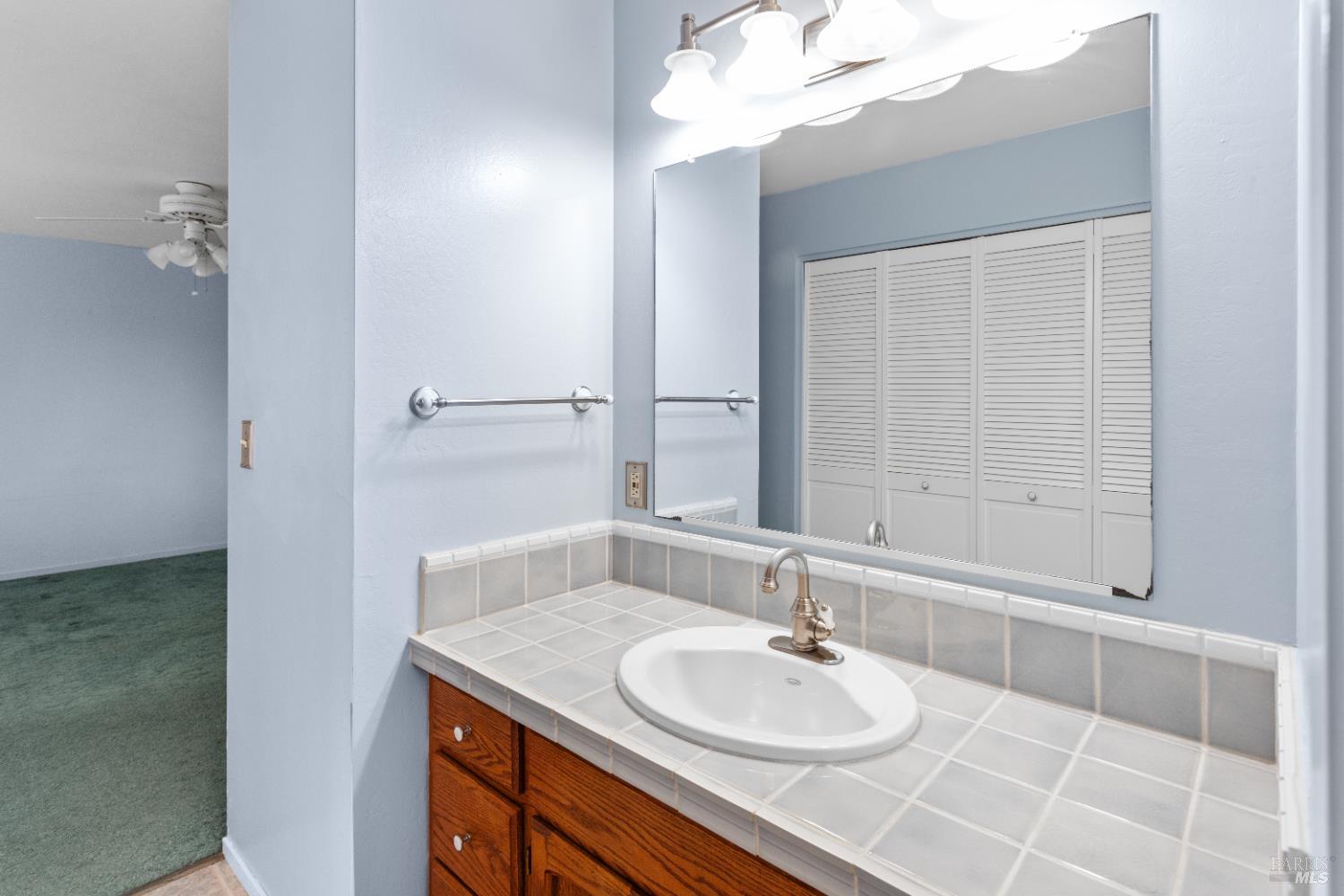 424 B Mason Street Healdsburg, CA 95448 - Photo 22 of 27 a bathroom with a sink and a mirror