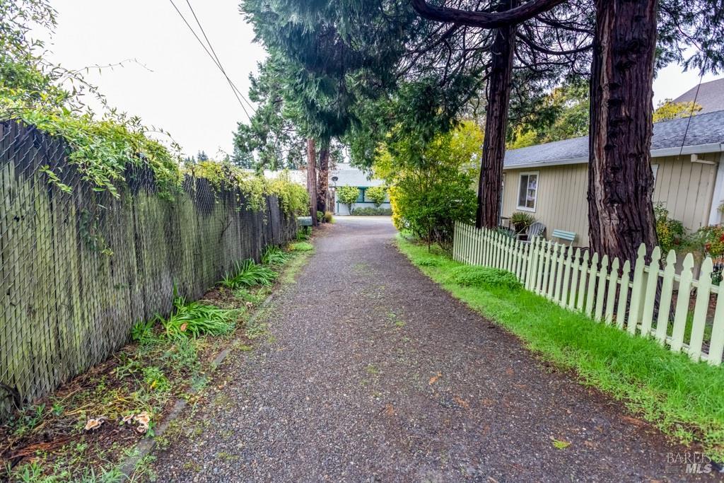 424 B Mason Street Healdsburg, CA 95448 - Photo 4 of 27 a view of a pathway of a house with large trees and wooden fence