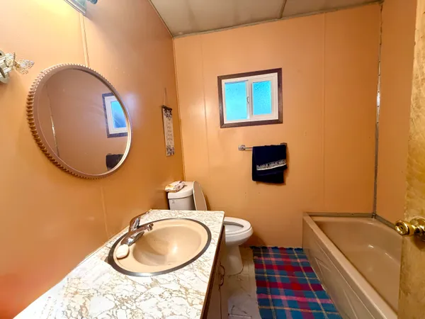 a view of backyard with barbeque grill and wooden fence