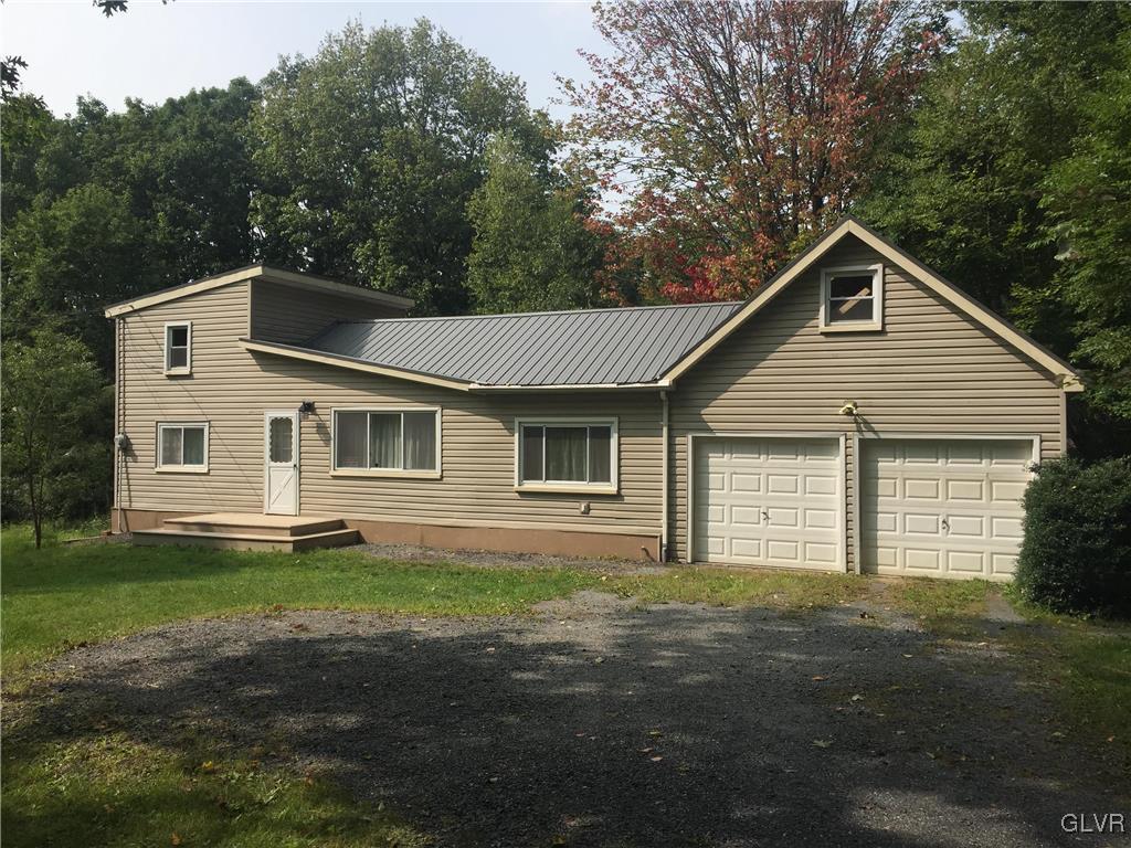 1710 Johns Road Effort, PA 18330 - Photo 1 of 27 a front view of a house with a garden