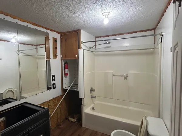 a bathroom with a tub and a sink