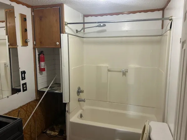 a bathroom with a bathtub and a shower