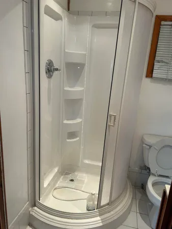 a bathroom with a toilet and a shower