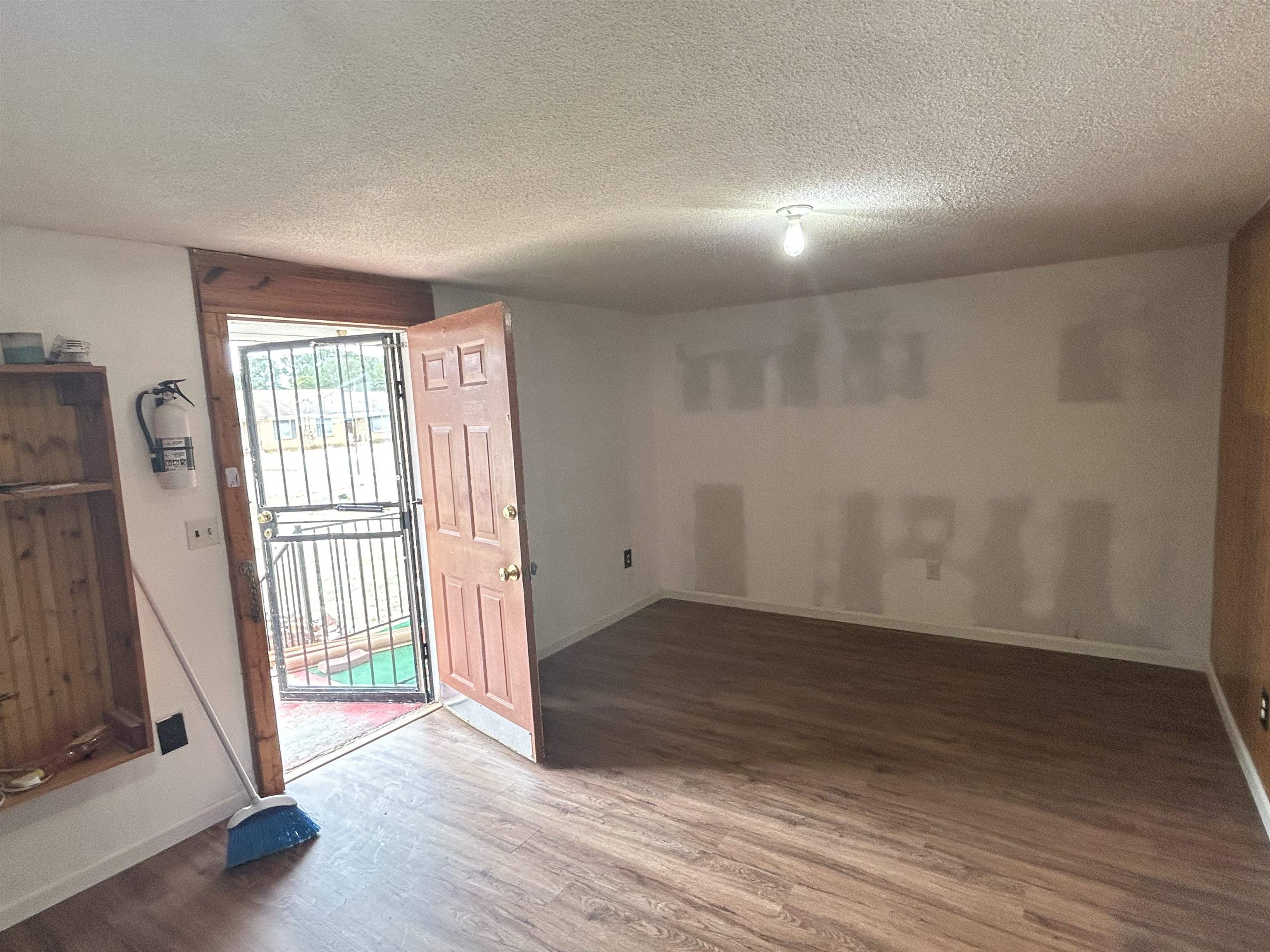 328 Ridgemont Drive Jackson, TN 38305 - Photo 9 of 12 wooden floor in an empty room with a window