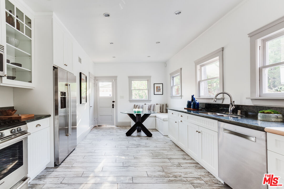 5850 Foothill Drive Los Angeles, CA 90068 - Photo 13 of 33 a kitchen that has a lot of cabinets in it and wooden floors