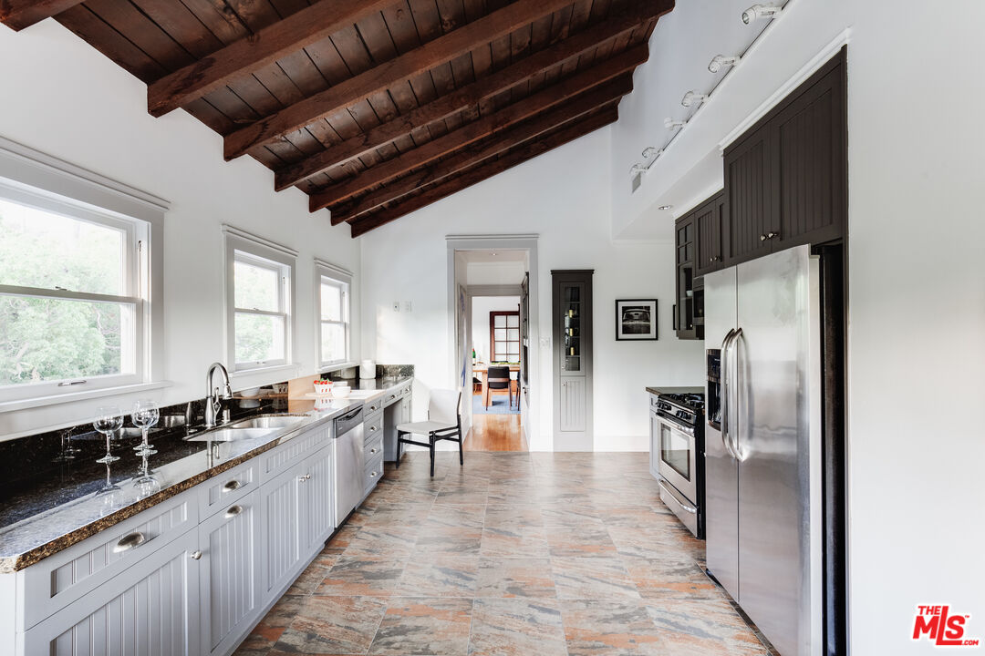 5850 Foothill Drive Los Angeles, CA 90068 - Photo 22 of 33 a large kitchen with stainless steel appliances kitchen island granite countertop a sink refrigerator and cabinets