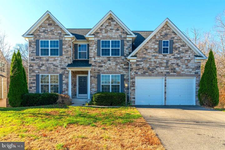 16272 Eagle Flight Circle Woodbridge, VA 22191 - Photo 1 of 19 a front view of a house with garden