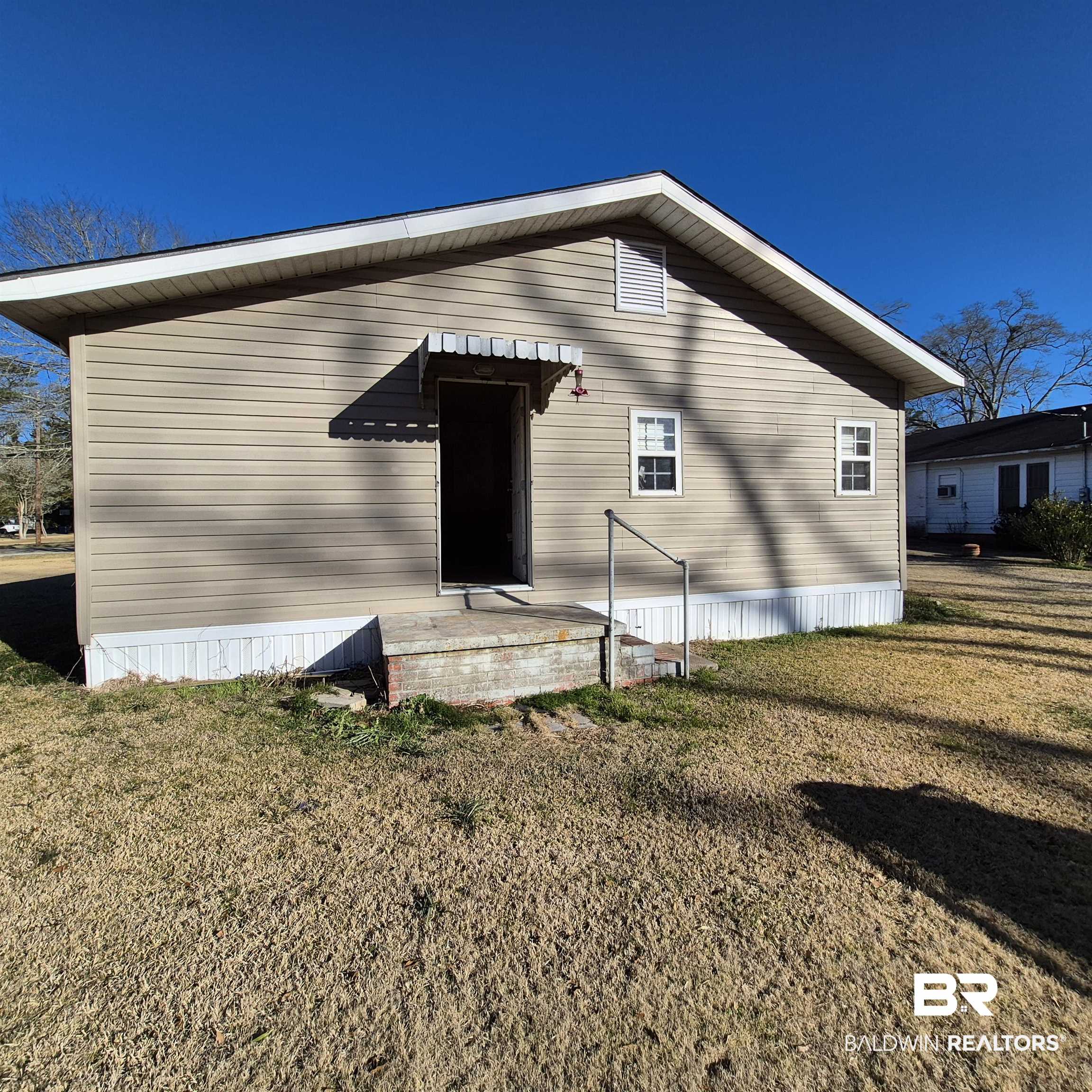320 Bruner Avenue Evergreen, AL 36401 - Photo 10 of 15 Rear view of property with a lawn