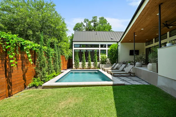 a view of a house with backyard porch and sitting area