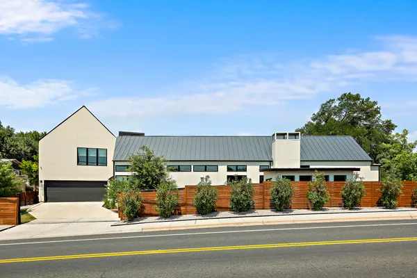 a view of a building and car parked on the road