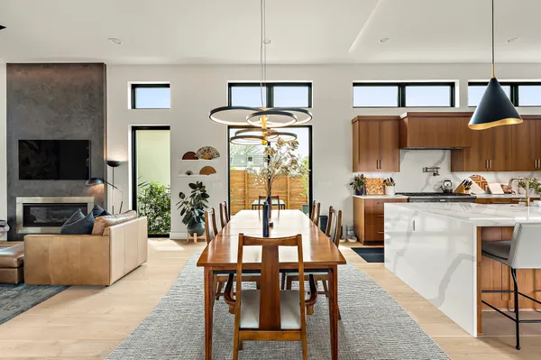 a living room with furniture a flat screen tv and kitchen view