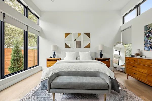 a bedroom with a bed and wooden floor