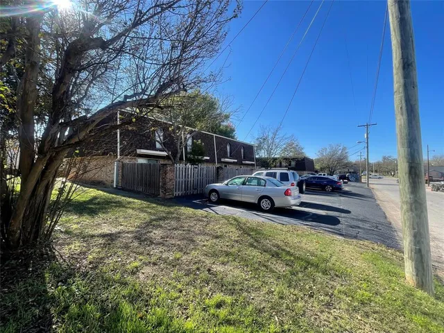a view of a backyard with parked cars