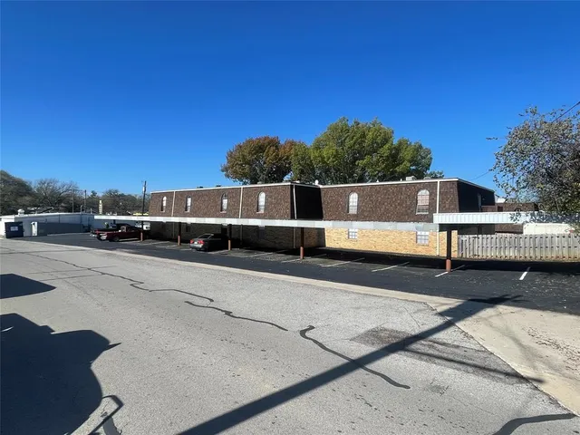 a view of city street with a car parked on the road