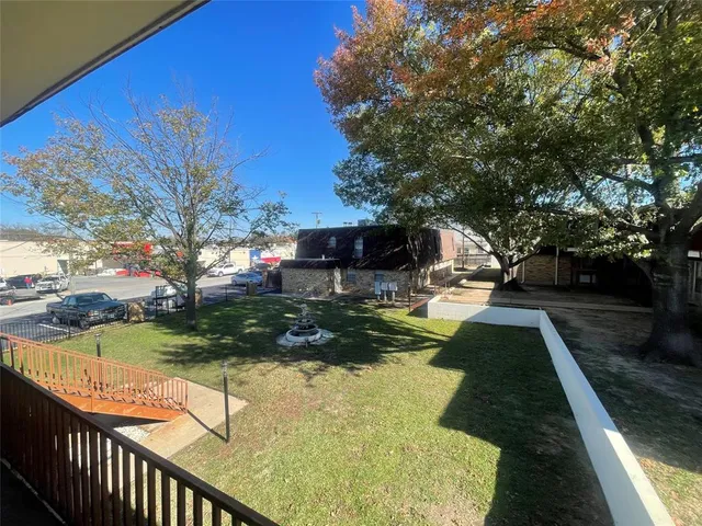 a view of a garden with wooden fence