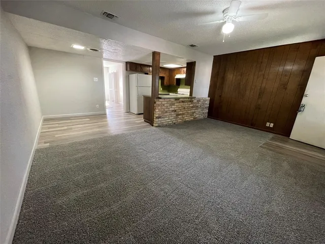 a view of a refrigerator in kitchen and wooden floor
