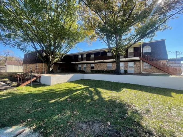 a view of swimming pool with lawn chairs and plants