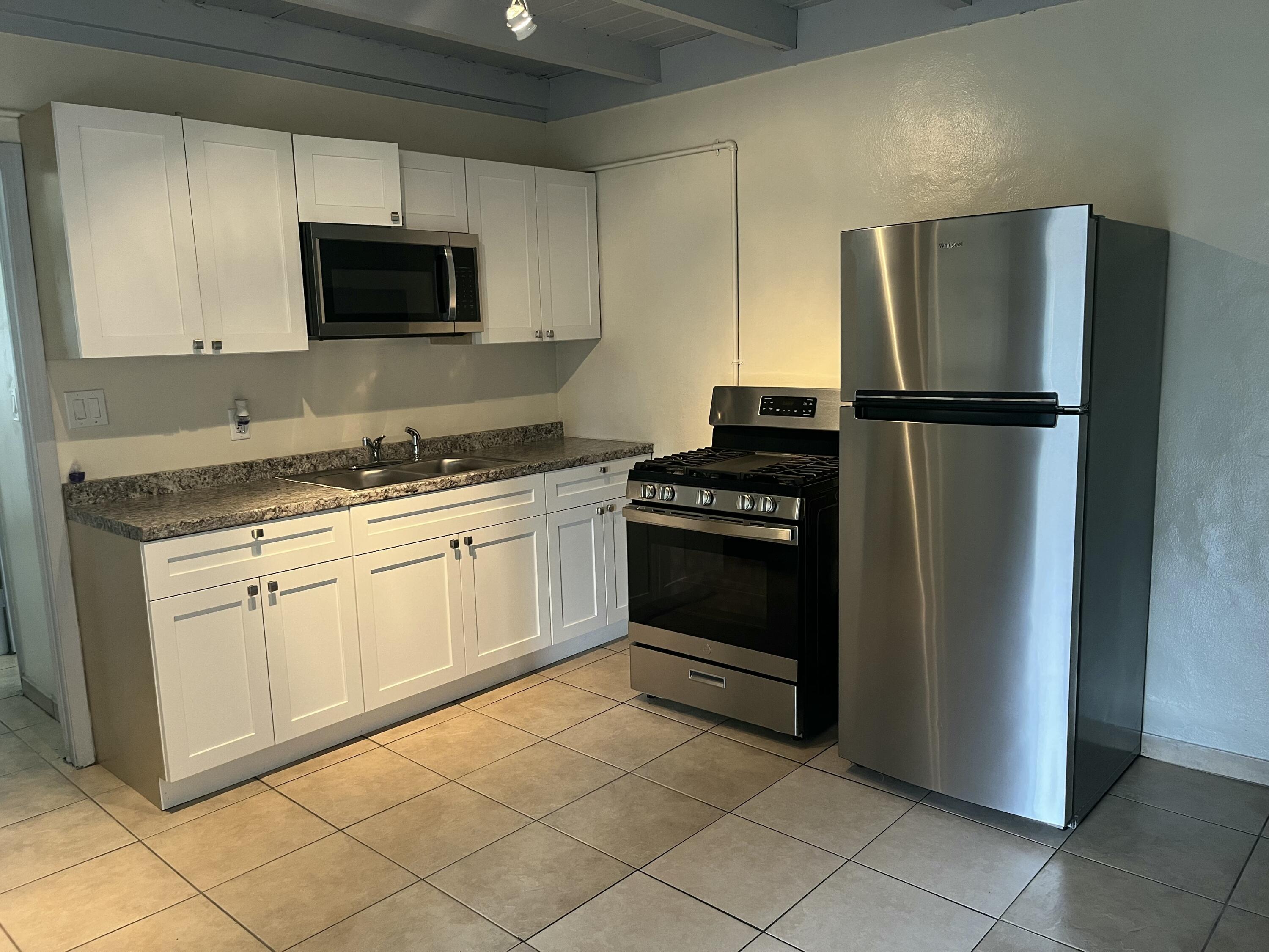 403 South 14th Street Fort Pierce, FL 34950 - Photo 5 of 19 a kitchen with a refrigerator stove and microwave