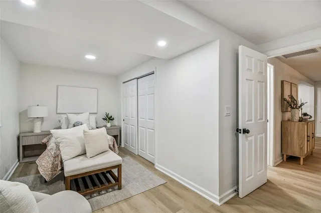 an empty room with wooden floor and window