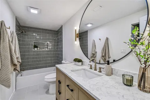 a kitchen with refrigerator and cabinets