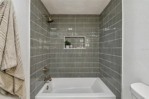 a kitchen with a refrigerator a stove a sink and chairs