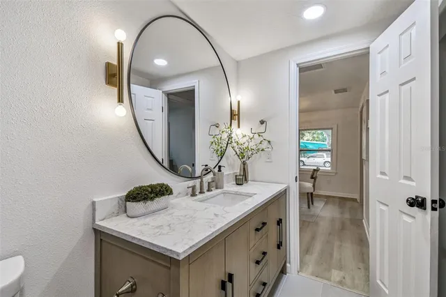 a bathroom with a sink and mirror