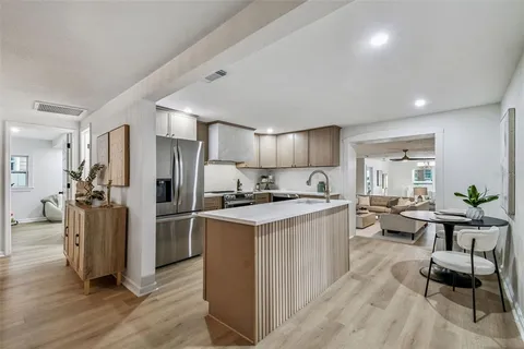 a kitchen with a refrigerator sink and stove