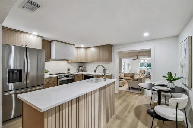 a living room with furniture and a floor to ceiling window
