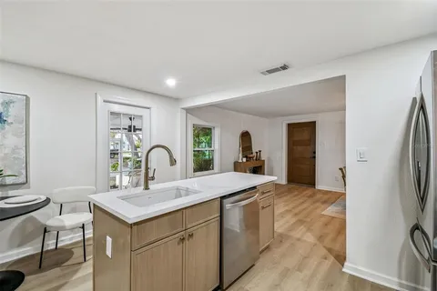an empty room with wooden floor and window