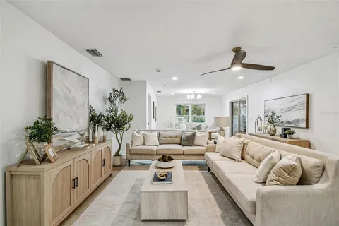 a room with two beds and a large window