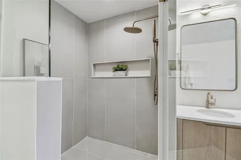 a bedroom with a bed a chandelier and a window