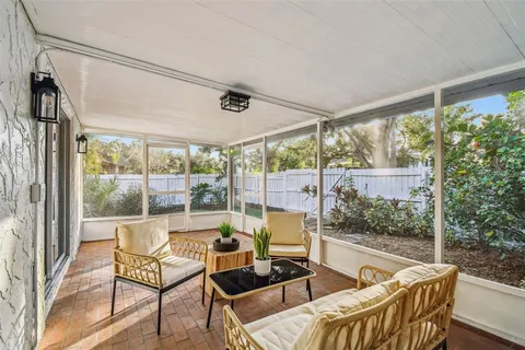 an aerial view of residential house with yard and mountain view in back