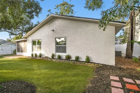 an aerial view of a houses with a yard