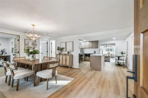 a dining room with furniture window and wooden floor