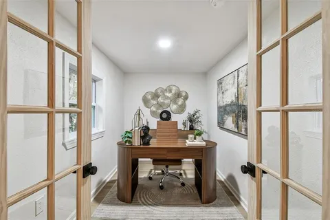 a view of a workspace room with furniture and wooden floor