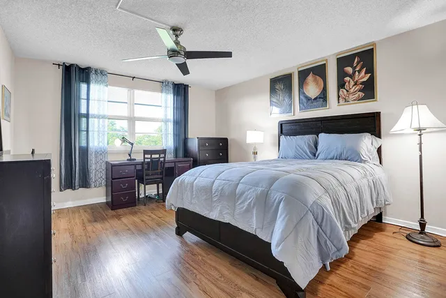 a bedroom with a bed and a desk