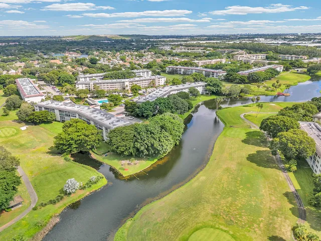 an aerial view of residential houses with outdoor space and swimming pool