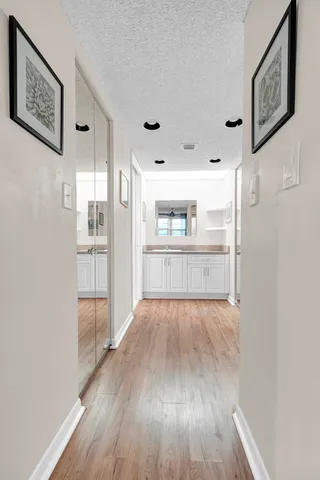 a view of a kitchen with wooden floor and a refrigerator