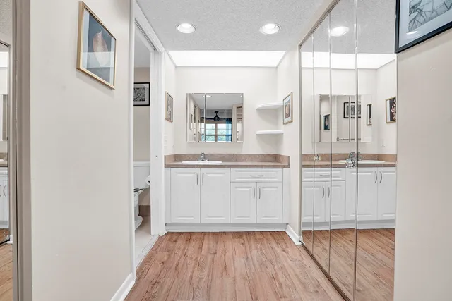 a kitchen with white cabinets and sink