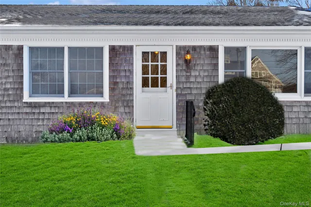 a view of empty room with wooden floor and fireplace