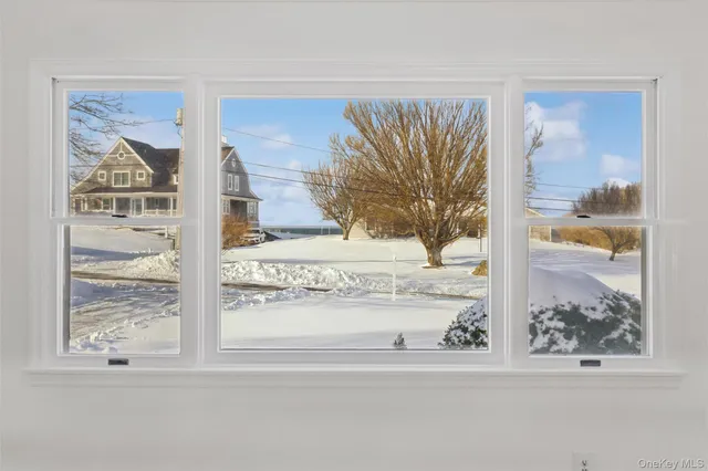 a view of empty room with wooden floor and fireplace