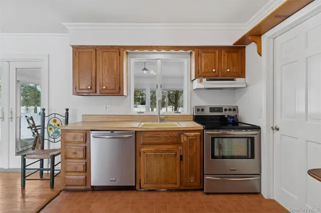 a kitchen with stainless steel appliances granite countertop a stove and cabinets