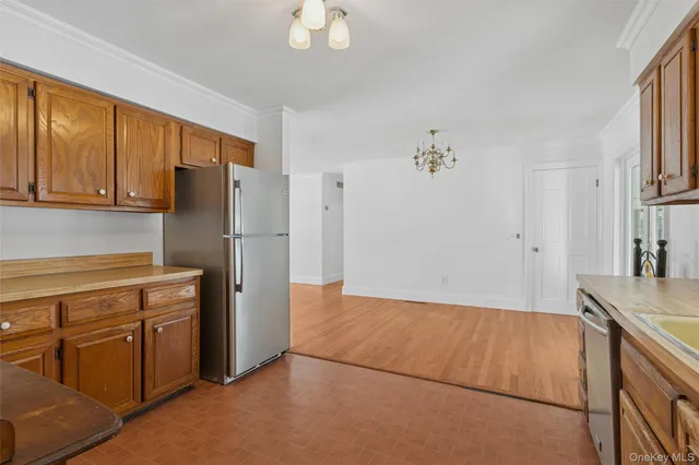 a kitchen with a refrigerator sink and cabinets